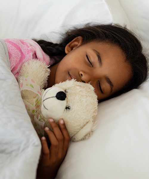 child asleep in bed